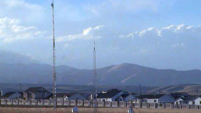 A field with a couple of antenna towers