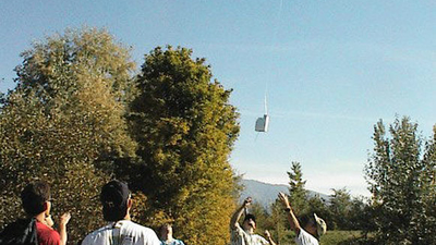 People releasing object suspended in the air